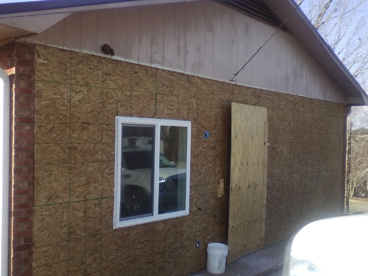 OSB sheathing on a garage addition wall before siding in Danbury
