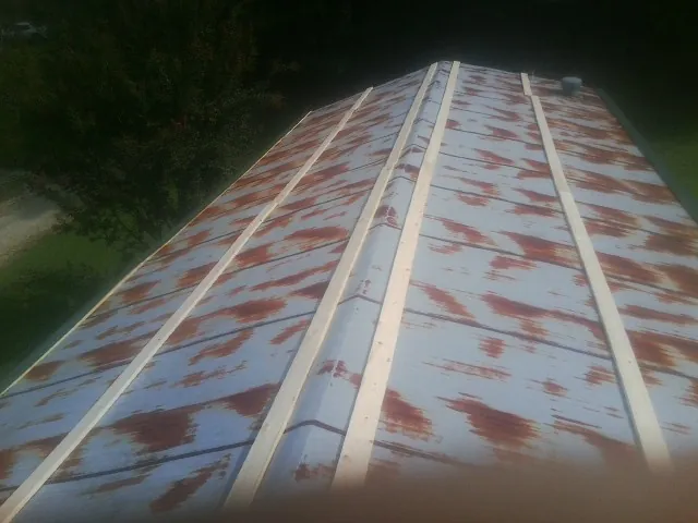 Rusted metal roof panels with new wood purlins before replacement — Storm Damage Roof Repair in Danbury by Roofing Brothers